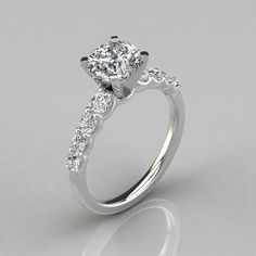 a diamond engagement ring with three stones on the side