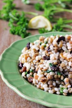 a green plate topped with grains and vegetables