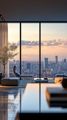 a living room filled with furniture and large windows overlooking a cityscape in the distance