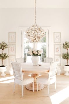 a dining room table with chairs and a chandelier