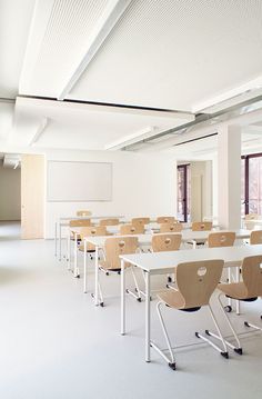 an empty classroom with desks and chairs