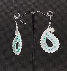 Stunning, statement, sterling silver paisley tear drop shaped earrings highlighted with tiny, turquoise coloured  glass beads.  The complex shapes of the earrings are skilfully hand sawn (pierced) from a sheet of recycled silver and then the beads are hand sewn into drilled holes.  The unique marriage of silver and beading is firmly secured and preserved with museum grade varnish.  The elegant earrings have an Eastern or Asian influence. Paisley or paisley pattern is an ornamental textile design Sterling Silver Teardrop Beaded Earrings, Teardrop Silver Beads Metal Jewelry, Beaded Sterling Silver Teardrop Earrings, Sterling Silver Teardrop Earrings With Silver Beads, Pierced Teardrop Metal Beaded Earrings, Pierced Teardrop Beaded Earrings, Traditional Silver Teardrop Beaded Earrings, Turquoise Teardrop Beaded Earrings As Gift, Turquoise Teardrop Beaded Earrings For Gifts