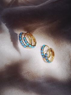 The prettiest blue opal hoops to sweeten your earlobes. These gold and cerulean blue opal huggie hoops shimmy and dance in the light day and night. Team them with with each other or mix and match with our other favorite hoop earrings. ✦ Choose your pair from two different sizes ✦✦ DETAILS ✦✧ Name: Kehaulani (keh-HOU-lah-nee) - Dew from the sky.✧ You will receive 1 pair.✧ Size 1: 10.5 x 2.25mm thick; 8.25mm inner diameter.✧ Size 2: 12.5 x 2.25mm thick; 9.75mm inner diameter.✧ Gold Plated Sterling Blue Small Hoop Huggie Earrings, Opal Huggie Hoop Earrings Gift, Gold Opal Huggie Earrings, Blue Hoop Huggie Earrings Gift, Opal Huggie Hoop Earrings As A Gift, Blue Hypoallergenic Small Hoop Huggie Earrings, Opal Huggie Hoop Earrings For Gifts, Blue Huggie Hoop Earrings As Gift, Blue Huggie Hoop Earrings For Gift