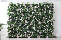 a wall covered in pink and white flowers