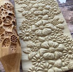 a wooden spoon sitting on top of a cutting board