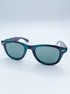 Our Vintage Wayfarer French Vintage Sunglasses are the perfect retro-look for any summer outfit. Crafted with a lightly colored frame and colorful lenses in orange, teal, red or blue, these sunglasses offer a unique, stylish look that stands out from the crowd. ​Details: Medium Squared Wayfarer Style Colors available: Blue, Teal, Red or Orange Freeform Color on Black Frame "Made in France" Printed on Temple Approximate Dimensions: 5.75" x 1.75" Light weight Retro Blue Wayfarer Sunglasses, Casual Blue Wayfarer Sunglasses, Casual Cat Eye Plastic Sunglasses, Retro Wayfarer Sunglasses With Anti-reflective Coating, Retro Anti-reflective Wayfarer Sunglasses, Retro Wayfarer Sunglasses With Uv Protection, Retro Green Polarized Sunglasses, Vintage Blue Sunglasses For Summer, Spring Cat Eye Wayfarer Sunglasses With Polarized Lenses