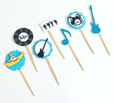 the cupcake toppers are decorated with musical instruments