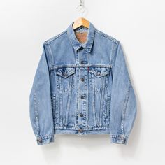 Vintage 90's Levi's denim jacket in classic stonewashed blue - 4 outer pockets - materials: 100% cotton denim SIZE: S MEASUREMENTS chest: 40 inches (102 cm) length: 24.5 inches (62 cm) sleeve length from the neck: 29.5 inches (75 cm) CONDITION - 8/10 - The jacket in great pre-owned vintage condition. Washed, ready to wear. Classic Light Wash Relaxed Fit Denim Jacket, Classic Washed Blue Denim Jacket With Pockets, Light Wash Recycled Denim Jacket For Streetwear, Classic Denim Jacket With Pockets In Recycled Denim, Classic Light Wash Denim Jacket, Blue Washed Denim Jacket From Recycled Material, Classic Faded Cotton Denim Jacket, Classic Blue Relaxed Fit Denim Jacket, Classic Blue Denim Jacket Relaxed Fit