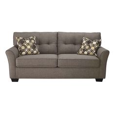 a gray couch with two pillows on it