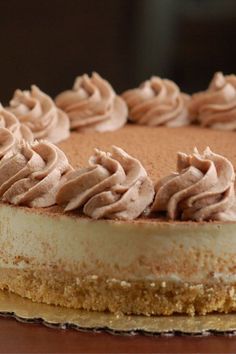 a cake with frosting sitting on top of a wooden table