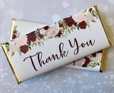 two candy bar wrappers with flowers and the words thank you written on one side