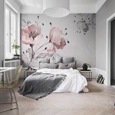 a bedroom with flowers painted on the wall