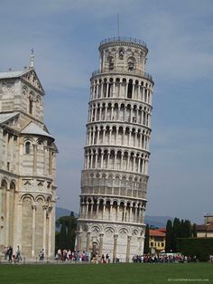 the leaning tower of pisa is shown in front of other buildings and people walking around