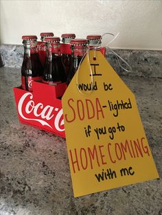 a coca - cola box with some soda bottles in it and a sign that says, i would be soda - lighted if you go to home coming with me