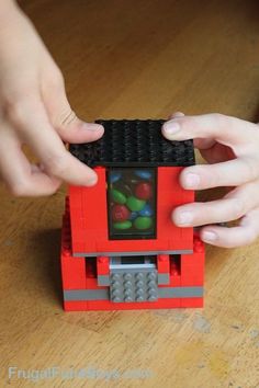 a child is playing with a toy truck made out of legos