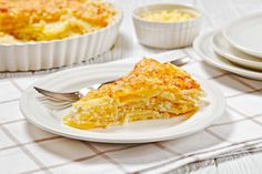 a slice of quiche on a plate with a fork and bowl of eggs in the background