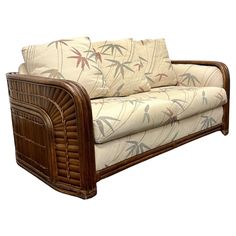 a couch that is made out of wood and has bamboo trimmings on it