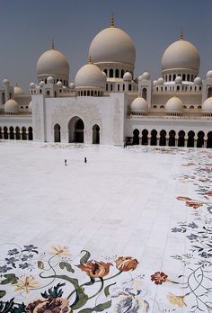 a large white building with many arches and domes