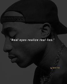 a man wearing a baseball cap with the words real eyes relize real lies