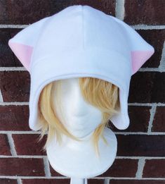 a wig wearing a cat hat on top of a white mannequin head