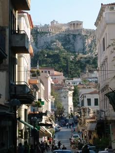 an old city street with cars parked on the side