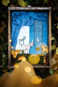 an image of a box that is on the ground with some decorations in it,