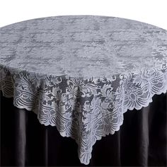 a round table with white lace on it