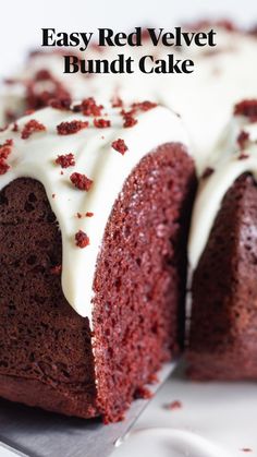 a red velvet cake with white frosting and sprinkled crumbs on top