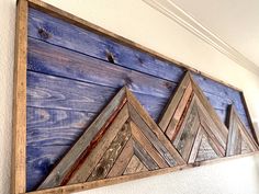 a wooden wall hanging on the side of a building