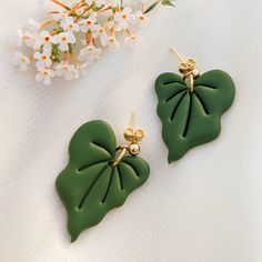 A stud / post for a person who loves plants and has a green apartment so that she can always have a piece of the jungle with her. The earrings are made of lightweight polymer clay. Metal elements are made of surgical steel, available in two colors (gold and silver). Surgical steel is a material that can be worn even by allergy sufferers. On request, I can make earrings in a different color and make a matching pendant. Length of the Earrings: 3,5 cm Earrings are handmade, so each piece may slightly differ. The delivery time for jewelry orders is about a week. Green Leaf-shaped Earrings For Gift, Green Leaf-shaped Earrings As A Gift, Green Leaf-shaped Earrings, Handmade Leaf-shaped Botanical Earrings, Handmade Botanical Leaf Earrings, Unique Leaf-shaped Earrings For Gift, Green Botanical Drop Earrings Jewelry, Botanical Green Drop Earrings, Green Botanical Drop Earrings