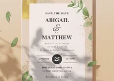 an elegant wedding card with greenery and gold foil on the front, featuring a silhouette of a bride and groom