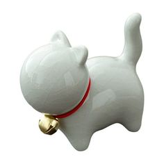 a white cat figurine with a bell on it's neck