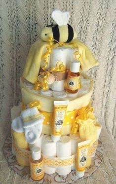 a cake made to look like a bee with lots of bees around it and baby items on top