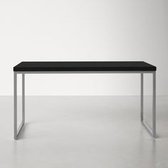 a black table sitting on top of a white floor