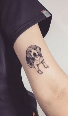 a small dog tattoo on the left arm