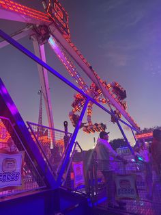 the carnival rides are lit up at night