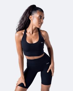 More than just a sports bra! It’s an eye-catcher no matter where you go. Strappy back and classy round neckline elongates your silhouette and adds a touch of chic to your look. Chic Workout Sports Bra With Built-in Bra, Chic Sports Bra With Built-in Bra For Workout, Black Sports Bra With Seamless Construction, Seamless Black Sports Bra With Minimal Stretch, Sleek Black Seamless Activewear, Black Scoop Neck Sports Bra For Gym, Black High Stretch Scoop Neck Sports Bra, Black Scoop Neck Activewear, Black Scoop Neck Sports Bra