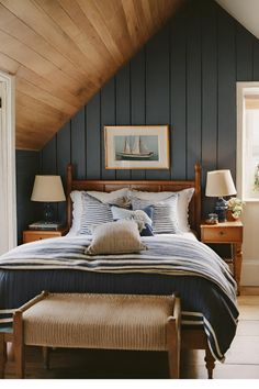 a bed sitting under a wooden ceiling in a bedroom