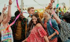 a group of people standing next to each other with streamers in the air above their heads