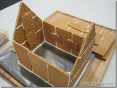 a gingerbread house made out of cardboard sitting on top of a table