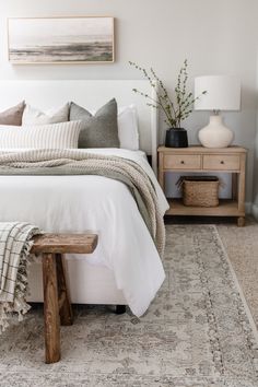 a white bed sitting in a bedroom on top of a rug