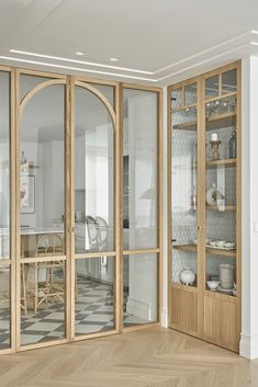 an empty room with wooden furniture and glass doors