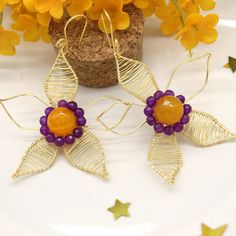 Large and beautiful are our handcrafted ROSELYN earrings in the shape of a flower delicately wrapped in golden copper wire accompanied by vibrant yellow agate and purple chalcedony gemstones giving a touch of color to each piece.
MEASUREMENTS
- Length Approx.: 3 Inch
- Width Approx.: 2.5 Inch
* Weight each earrings Approx. : 0.25 oz.
.
#handmadejewelry #flowerearrings #dangleearrings #bohoerrings #bohojewelry #gemstoneearrings #gemstonejewelry #wirejewelry #wirewrappedjewelry #giftforher Artisan Wire Wrapped Beaded Earrings, Handmade Gold Earrings With Flower Pendant, Handmade Flower Gold Earrings For Gift, Gold Earrings With Handmade Flowers As Gift, Gold Earrings With Handmade Flowers For Gift, Artisan Flower Earrings, Flower Charm Earrings With Round Beads As A Gift, Flower Charm Earrings With Round Beads For Gift, Adjustable Beaded Earrings With Flower Charm For Gifts