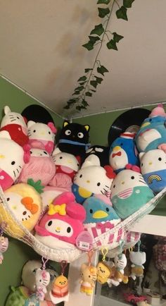 a bunch of hello kitty stuffed animals hanging from the ceiling