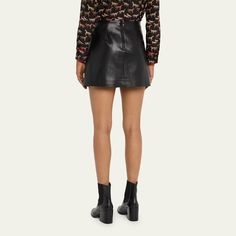 Alice + Olivia "Toni" vegan leather (PU/polyester) skirt finished with side pleating High rise  Hem falls above the knee Finished with pleating Center back zip Lining: Polyester Dry clean Imported Black Pleated Mini Skirt, Zip Lining, Leather Pleated Skirt, Polyester Skirt, Pleated Mini Skirt, Alice Olivia, Above The Knee, Pleated Skirt, The Knee