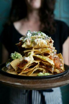 a woman holding a plate full of food