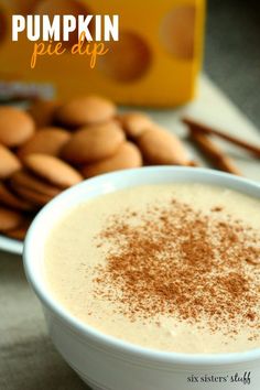 a bowl of pumpkin pie dip with cinnamon sprinkles on the side and an orange box in the background