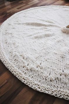 a close up of a white rug on a wooden floor