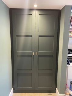 two gray double doors in the corner of a room