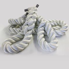 white rope with black handle on grey background